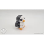 Penguin articulated fidget toy compressed flat showing articulated segments from back, demonstrating full range of motion — 3D printed articulated fidget toy by Sensory Sidequest