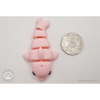 Pink Baby Dolphin 3D printed articulated fidget toy shown with Australian 50 cent coin for scale — Sensory Sidequest Australia
