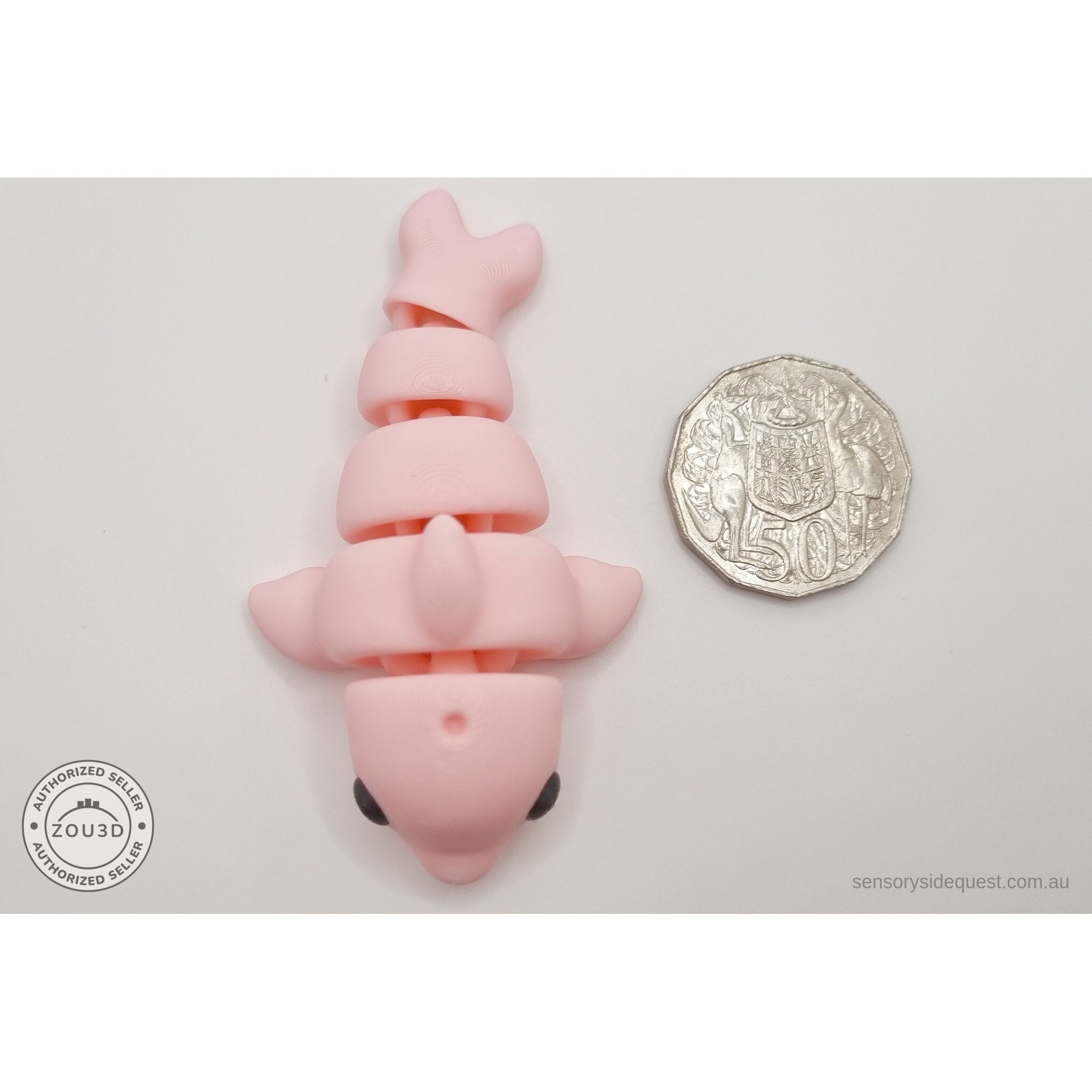 Pink Baby Dolphin 3D printed articulated fidget toy shown with Australian 50 cent coin for scale — Sensory Sidequest Australia
