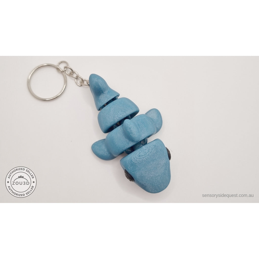 027-TNYSHK Tiny Shark keychain in gentian blue — upright dangling view showing all body segments stacked vertically with keychain ring at top — 3D printed articulated fidget toy by Sensory Sidequest