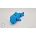 024-SHK Baby Shark in cyan matte, 3/4 front lying view — 3D printed articulated fidget toy by Sensory Sidequest