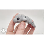 Baby Manatee 3D printed fidget toy held in hand showing size — Sensory Sidequest