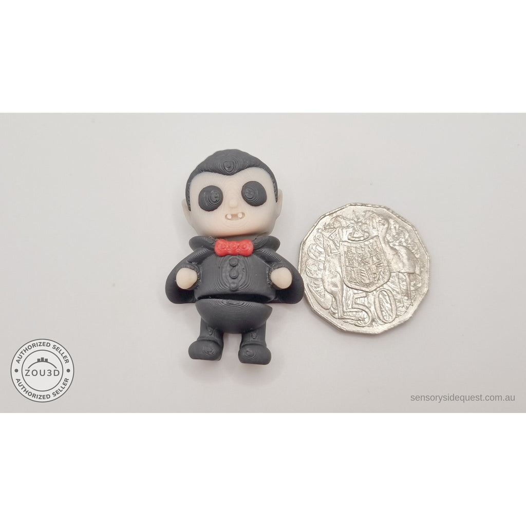 Tiny Dracula articulated fidget toy next to Australian 50c coin for size reference — own photo by Sensory Sidequest